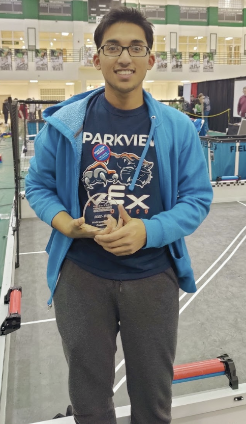 Vedarsh holding a VEX Robotics award